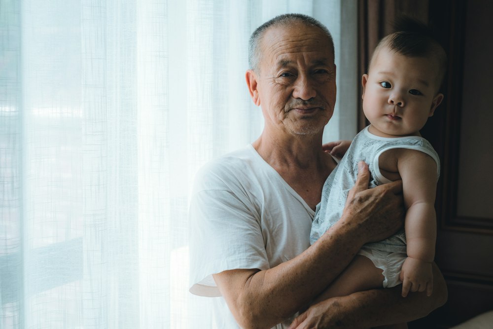 A grandfather holding his grandchild